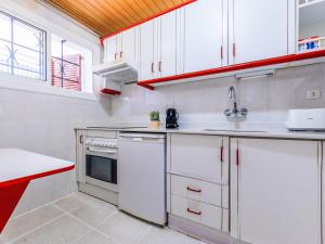a kitchen with white cabinets and a sink at Apartment Delfines by Interhome in Cambrils