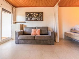 a couch in a living room with a painting on the wall at Apartment Delfines by Interhome in Cambrils