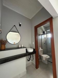 a bathroom with a sink and a mirror and a toilet at Casa Prado in Prado +18 photos