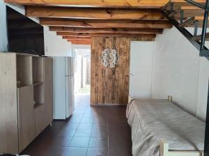 a bedroom with a bed and a wooden ceiling at Alvear centro hospedaje 2 in General Alvear