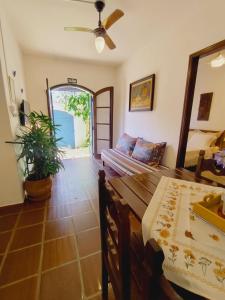 a living room with a bed and a mirror at Quinta essência suites e chalés in Ubatuba