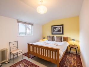 a bedroom with a large bed and a window at Chalet The Chalet by Interhome in Fort Augustus