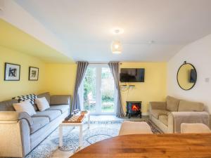 a living room with a couch and a fire place at Chalet The Chalet by Interhome in Fort Augustus
