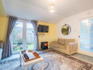 a living room with a couch and a chess board on a table at Chalet The Chalet by Interhome in Fort Augustus