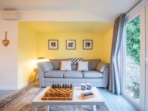 a living room with a couch and chessboard on a table at Chalet The Chalet by Interhome in Fort Augustus +48 photos