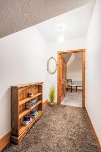a hallway with a door leading into a room with a table at Apartment Pond View on Aigas Golf Course by Interhome in Beauly