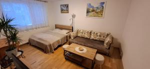a small bedroom with a bed and a table at Apartment KRIVÁŇ in Vyšné Hágy