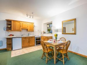 a kitchen with a table and chairs in a room at Apartment Old Stable on Aigas Golf Course by Interhome in Beauly