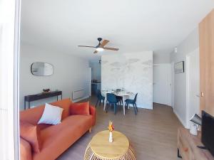 a living room with a couch and a table at Holiday Home Bretons by Interhome in Capbreton