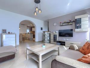 a living room with a couch and a table at Apartment L&V by Interhome in Galižana