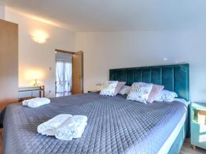 a bedroom with a large bed with towels on it at Apartment L&V by Interhome in Galižana