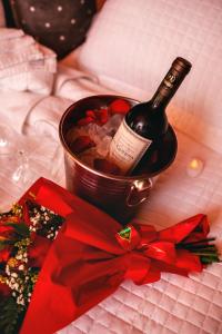 a bottle of wine in a bucket with a bow at Resort Pedra do Sonho in Janaúba