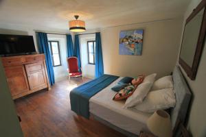 a bedroom with a bed and a television in it at Casa Una Storia in Sartène