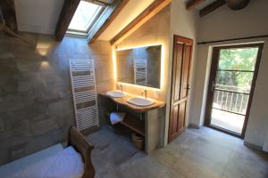 a bathroom with two sinks and a large mirror at Casa Una Storia in Sartène +22 photos