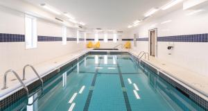 a large swimming pool with blue water at Prestige Golden Hotel in Golden