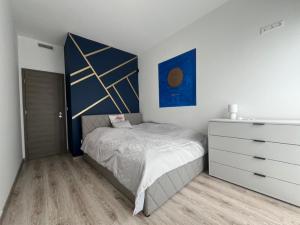 a bedroom with a bed and a dresser at Sissy Ring House in Mogyoród