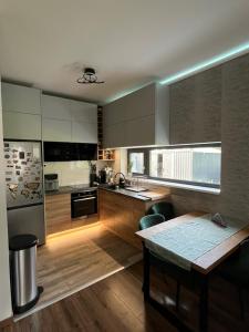 a kitchen with wooden floors and a table in it at Sissy Ring House in Mogyoród