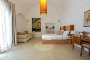 a bedroom with a bed and a couch at Dimora Lùmina in Gallipoli +47 photos