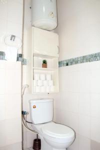 a white bathroom with a toilet and a sink at AZURA Skyline in Abidjan +13 photos