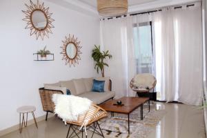 a living room with a couch and a table at AZURA Skyline in Abidjan