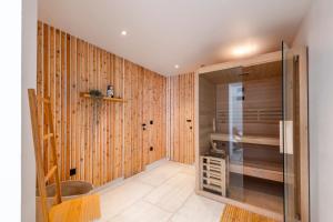 a room with wood paneled walls and a walk in closet at Luxury Private Spa Apartment with Heated Pool & Sauna and Sea View in Cavtat