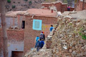 a group of people walking up a mountain at Atlas House in Amizmiz +5 photos