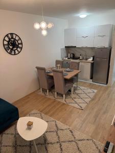 a living room with a table and a kitchen at Apartman Odmor012-2 in Požarevac