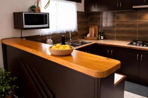 a kitchen with a bowl of oranges on a counter at Vunakavika House - Village Stay in Nadi