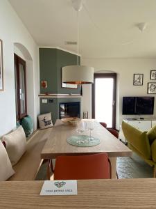 a living room with a table with wine glasses on it at casa prima vista in Torri del Benaco