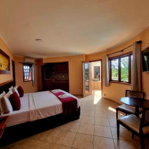 a bedroom with a bed and a table and windows at IL Nuraghe in Canoa Quebrada +94 photos