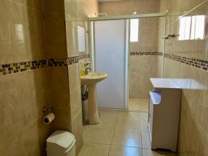 a bathroom with a toilet and a sink and a shower at 4 VENATOR House Boutique in León