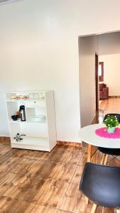 a dining room with a table and a chair at Casa da Ana in Tutóia