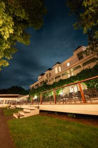 a building with tables and chairs in a yard at night at Basin Harbor in Vergennes