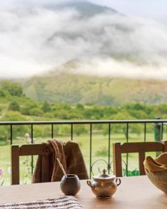 a table with a tea pot on a table with a view at El Caserío Jujuy in Volcán +20 photos
