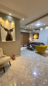 a living room with a painting of a deer on the wall at 2 bedrooms apartment no 18 in Amman