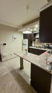 a kitchen with a counter with a vase of flowers on it at 2 bedrooms apartment no 18 in Amman