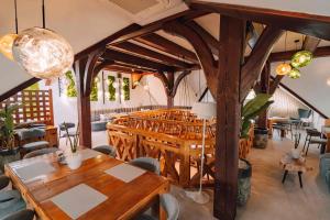 a dining room with wooden tables and chairs at Zajazd Fojutowo in Legbąd