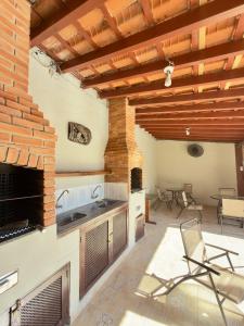 a kitchen with a fireplace and a table and chairs at Studio VI até 7 pessoas em Juquehy in São Sebastião
