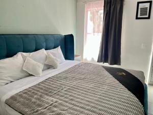 a bed with a blue headboard in a bedroom at 11 VENATOR House Boutique in León +8 photos