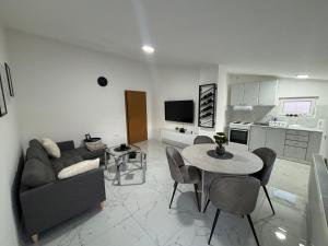 a living room with a couch and a table at Apartman Rose in Čapljina