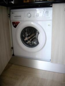 a white washing machine with its door open at Lemon in the Air in Scala