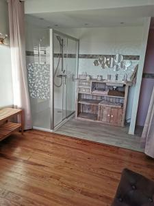 a bathroom with a shower and a wooden floor at chambres randonneurs in Plestin-les-Grèves +28 photos