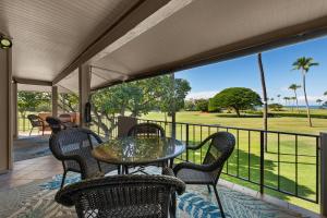 a patio with a table and chairs on a balcony at Maui Eldorado H202 in Kaanapali