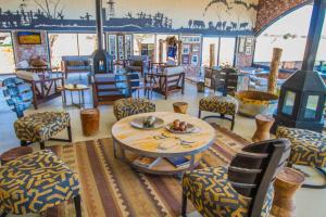 a room with a table and chairs in a restaurant at Okonjima Plains Camp in Otjiwarongo