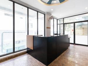 a room with large windows and a black counter at OYO 70156 Victorian Comforts in Bangalore +43 photos