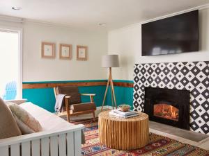 a living room with a couch and a fireplace at Cambria Beach Lodge in Cambria