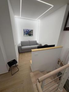 a living room with a couch and a table at Elegante suite con box privato e vista in Aprica