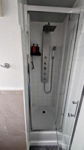 a shower with a glass door in a bathroom at Studio cosy à deux pas de Paris in Clichy +4 photos
