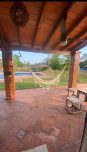 a porch with a hammock and a picnic table at Casita de Natalia in San Bernardino +17 photos