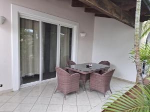 a patio with a table and chairs on a porch at Tamarindo in Bayahibe